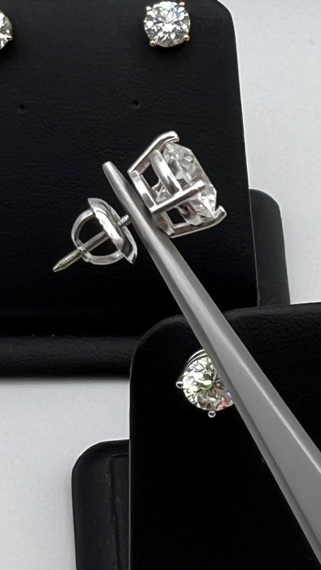 Side view of  not the actual 3.0 ctw Diamond Earrings shine with two perfectly matched 1.5 ct round diamonds, nestled in timeless four-prong white gold settings 