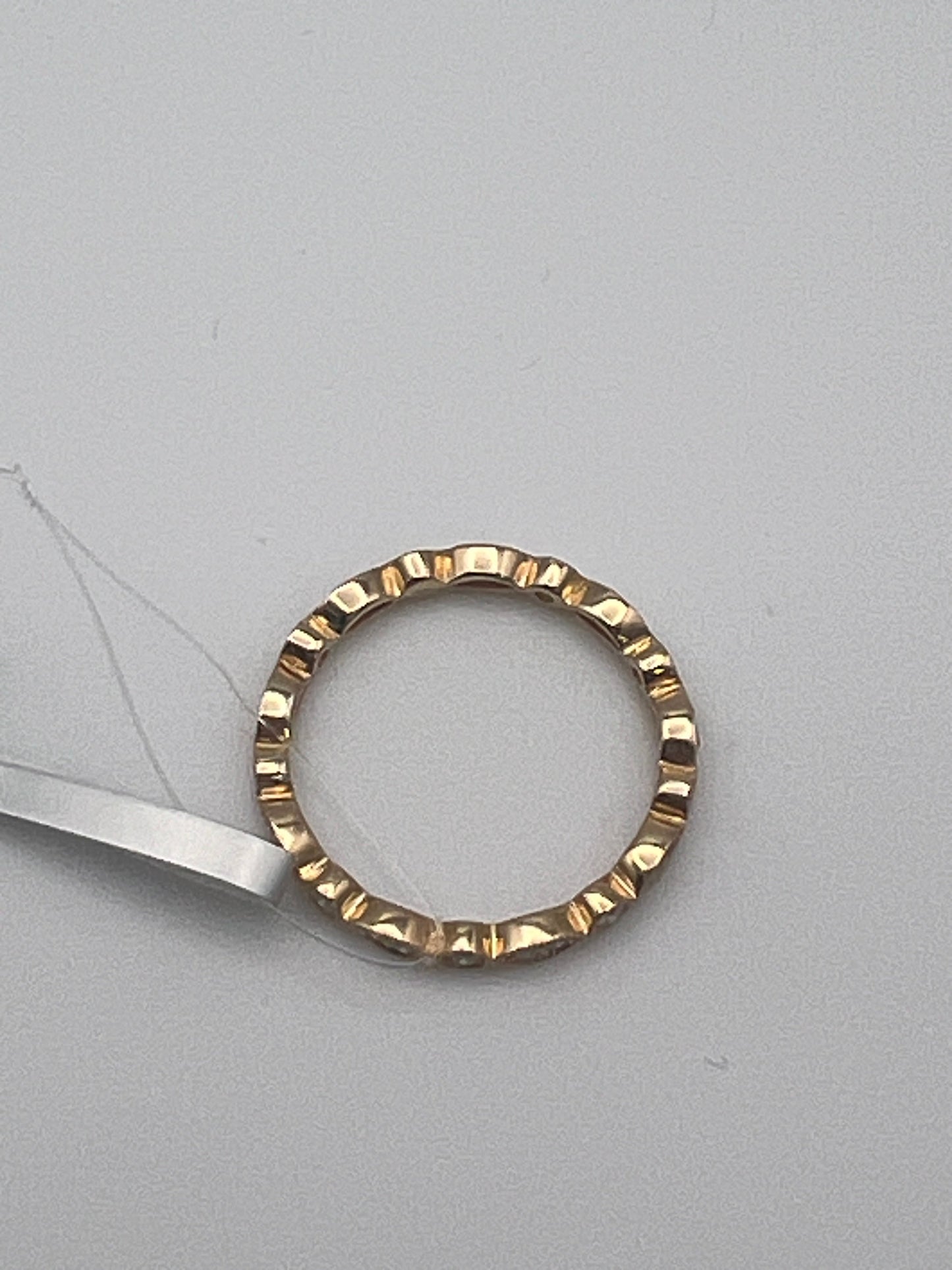 back of Elegant 14k Yellow Gold Diamond Band. That's not a hair. It's the plastic string for the tag.