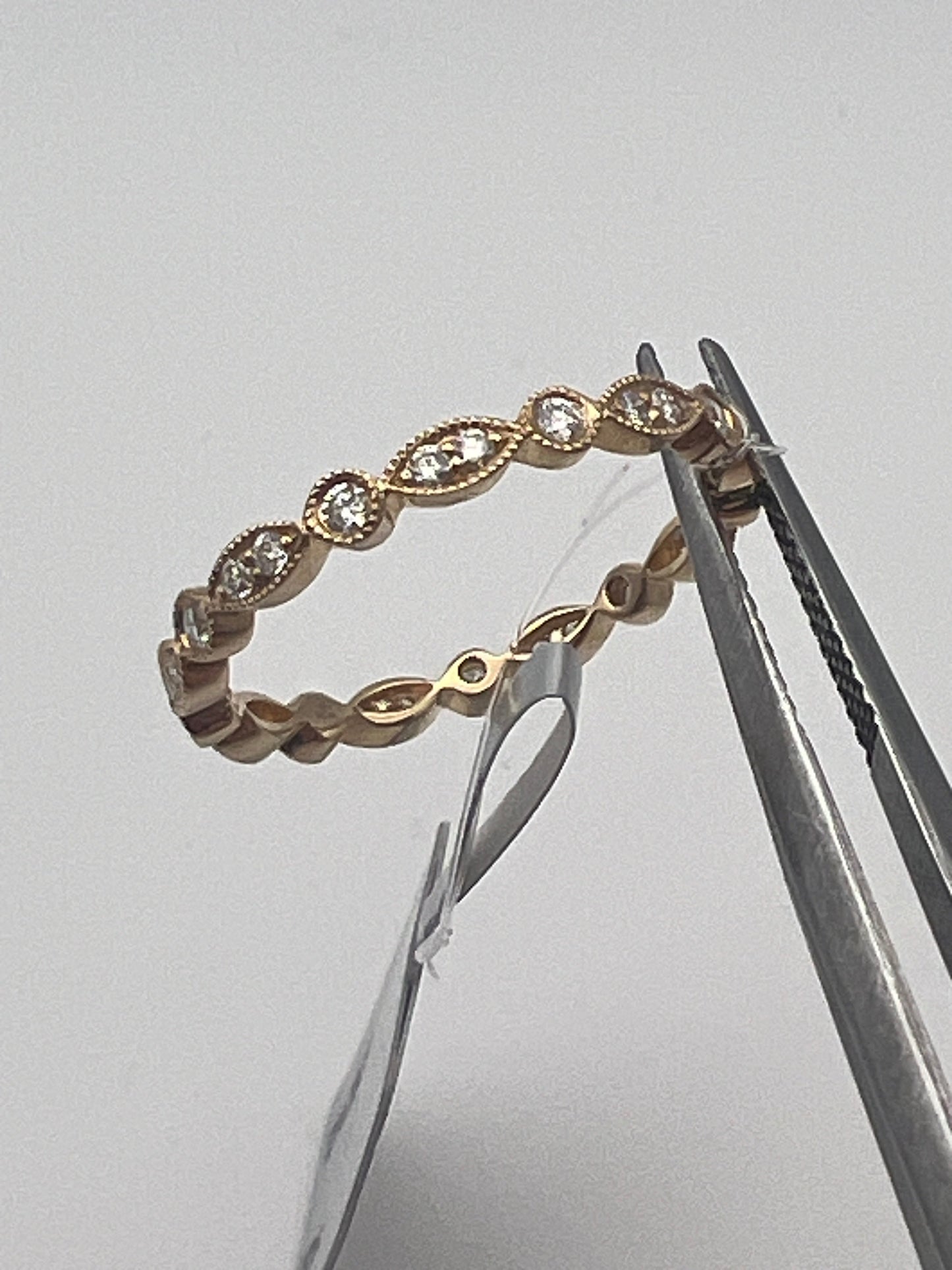 a better view of the elegant gold band with small round and marquis diamonds