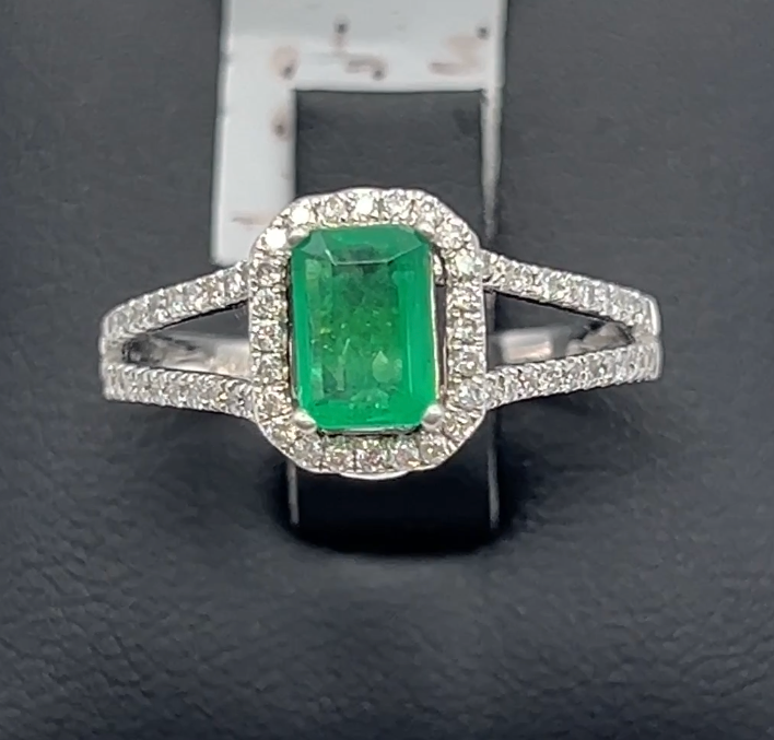 Stunning 1 Ct natural emerald ring with 2.33 Ct diamond halo set in a sophisticated 14k white gold band, embodying luxury and style.