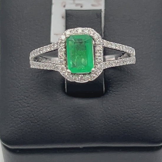 A noisy video of a Stunning 1 Ct natural emerald ring with 2.33 Ct diamond halo set in a sophisticated 14k white gold band, embodying luxury and style.